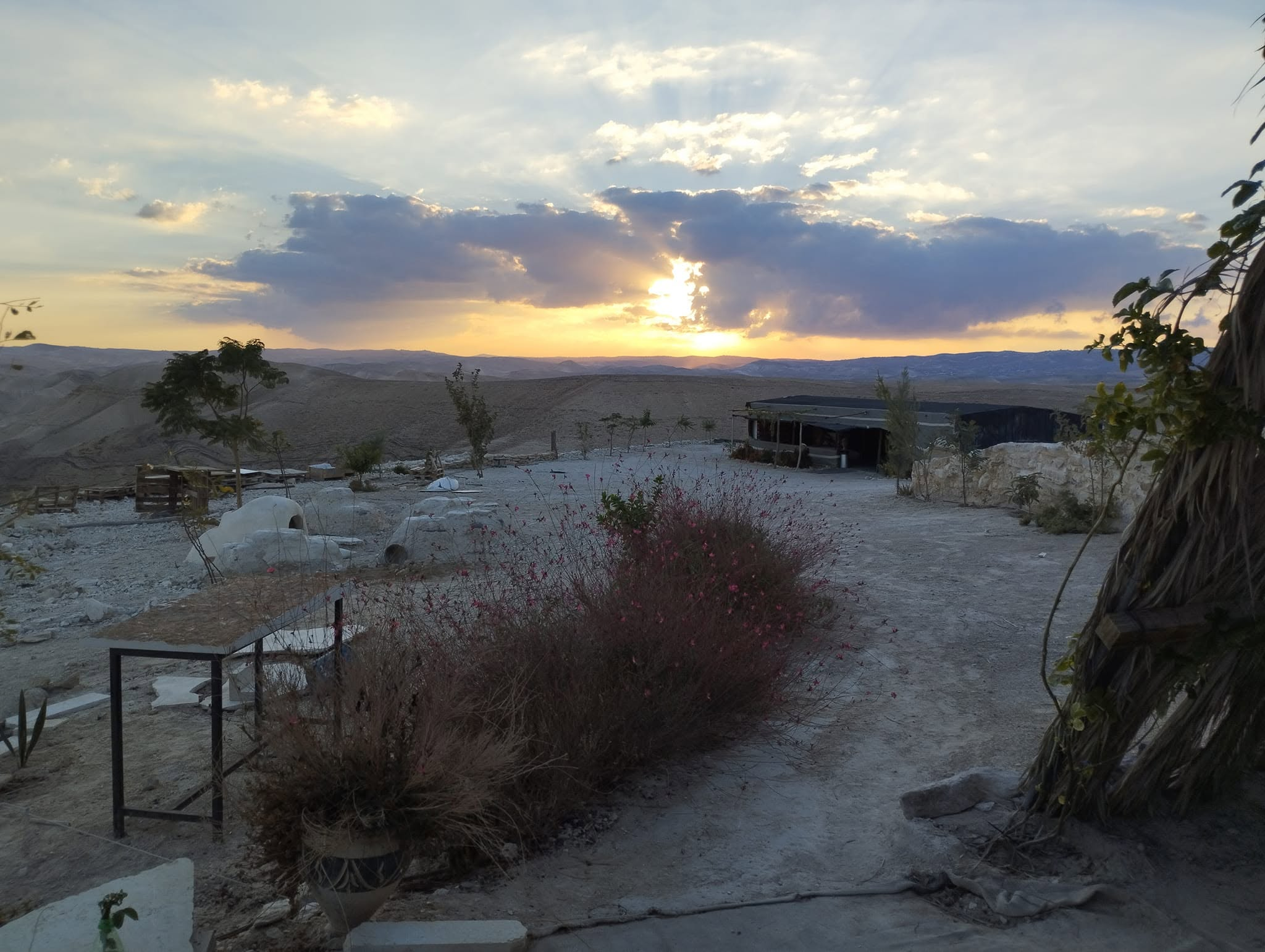 The camp and desert hills at sunset