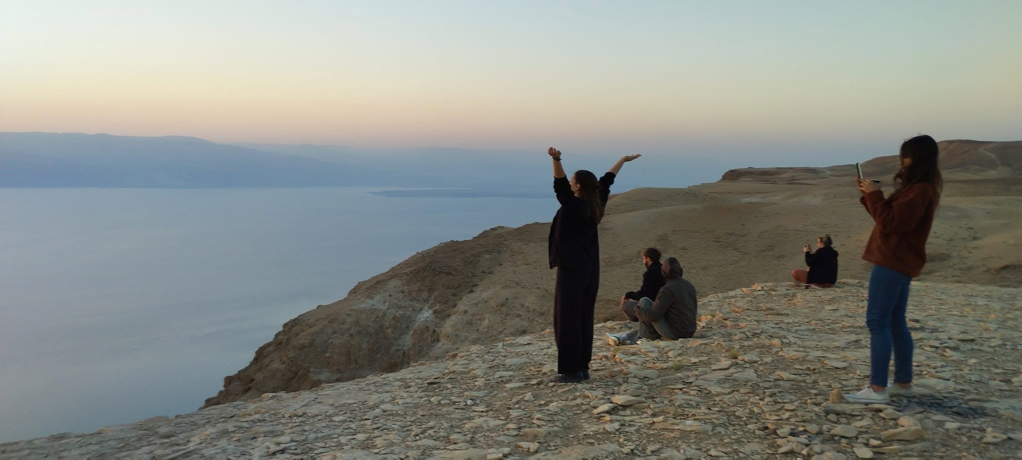 Participants overlooking the Dead Sea from a desert ridge