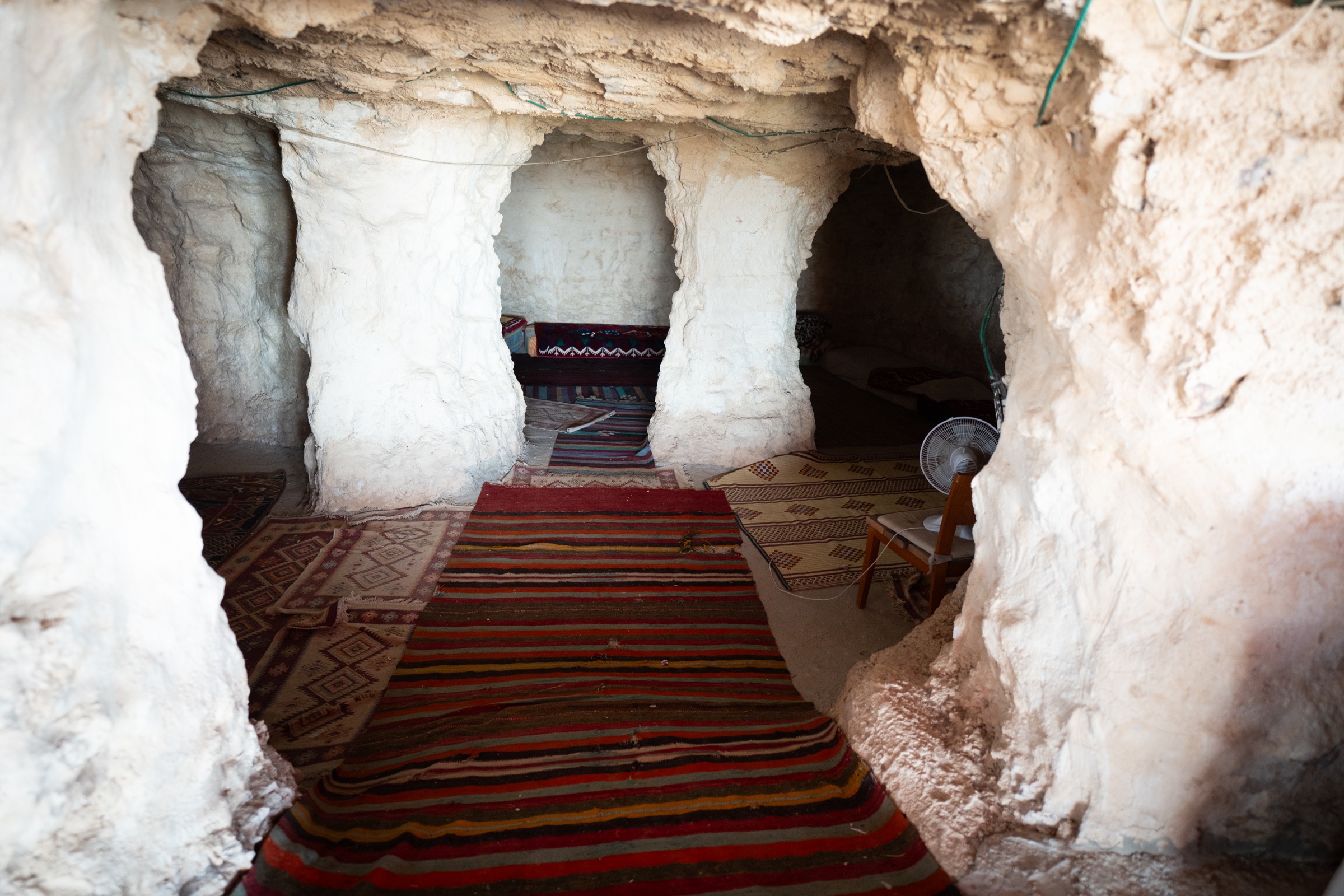 Stone rooms at the Bedouin camp lined with woven rugs