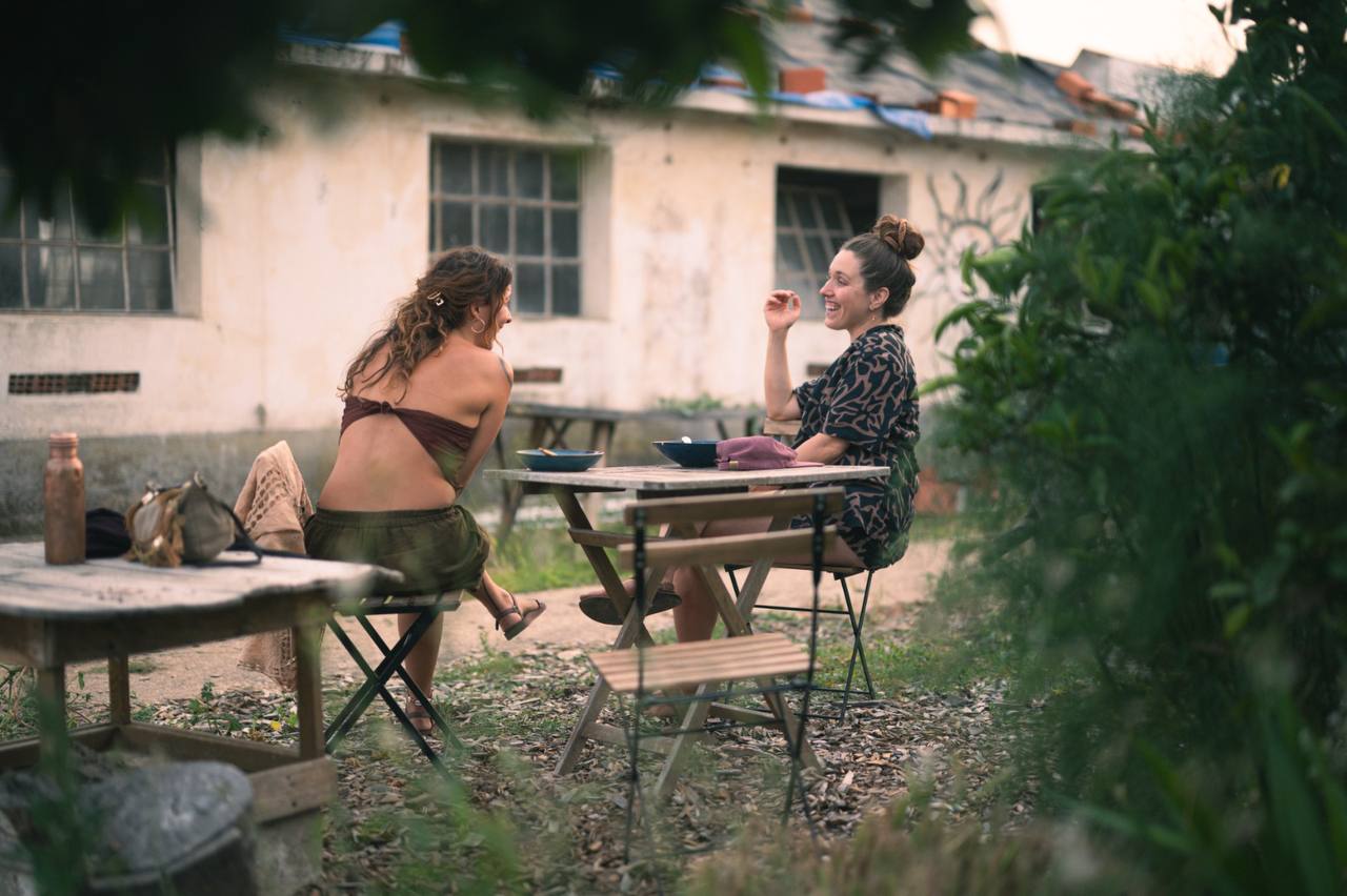 Two people in conversation over a meal in the garden